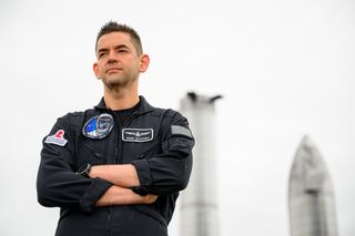 Jared Isaacman stands in front of prototype starships