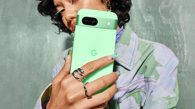 Woman with Google Pixel 8a in aloe (lifestyle)