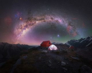 The rainbow of the Milky Way photographed above a lone camping tent on top of Aoraki National Park/Mt Cook, New Zealand