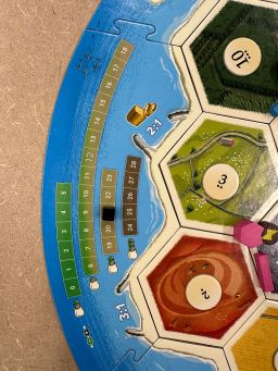 On the side of the Catan: New Energies scoreboard, a small black marker tracks the level of greenhouse gases in the current game.