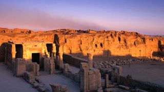 The sunrise begins to awaken the ruins of the small temple in front of the now illuminated more majestic remains of the temple of Horus.