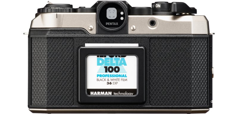 Vintage Pentax film camera with a loaded roll of Ilford Delta 100 Professional black and white film.  The camera has a textured black handle and metal top with various buttons and dials visible on top.