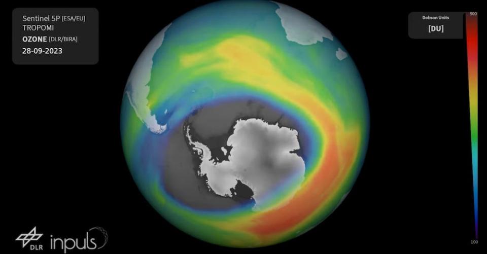 A still from the European Space Agency video showing a multicolored visualization of the ozone layer above the globe, with Antarctica visible through a massive pinhole, from September 28, 2023.