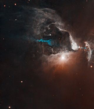 A bright point of light shines near center right with diffraction spikes, surrounded by glowing clouds against a background of black space.  A blue plume of material extends roughly through the center of the image, partially obscured by clouds