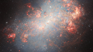 Read more about the article See Explosive Galaxy Flaming From Explosive Star Birth Swallowing Dwarf Galaxies (Video)