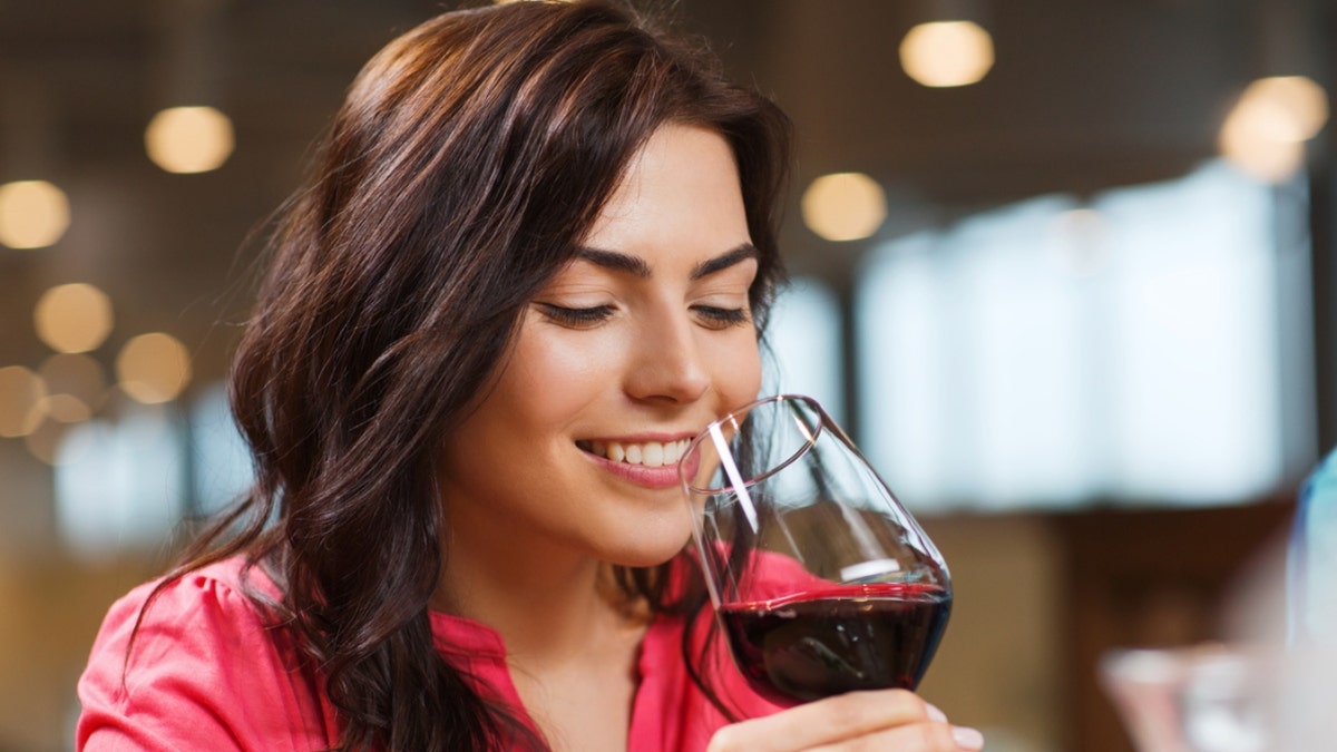 a woman drinks a glass of wine