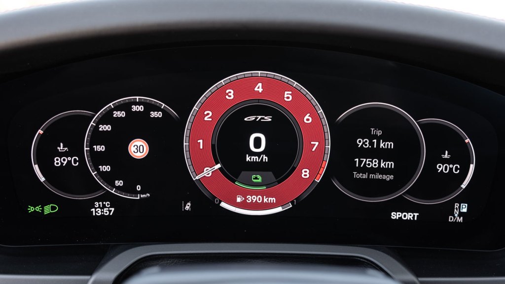 A close-up of the digital instrument cluster in a hybrid Porsche 911 Carrera GTS.