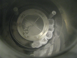 Experimental samples loaded into the specially designed dewar, which will soon be filled with liquid nitrogen and placed under gamma radiation.  Note that the flame-sealed test tubes are wrapped in cotton cloth to hold them together, because the tubes become buoyant in liquid nitrogen and begin to float around in the dewar, preventing proper radiation exposure.